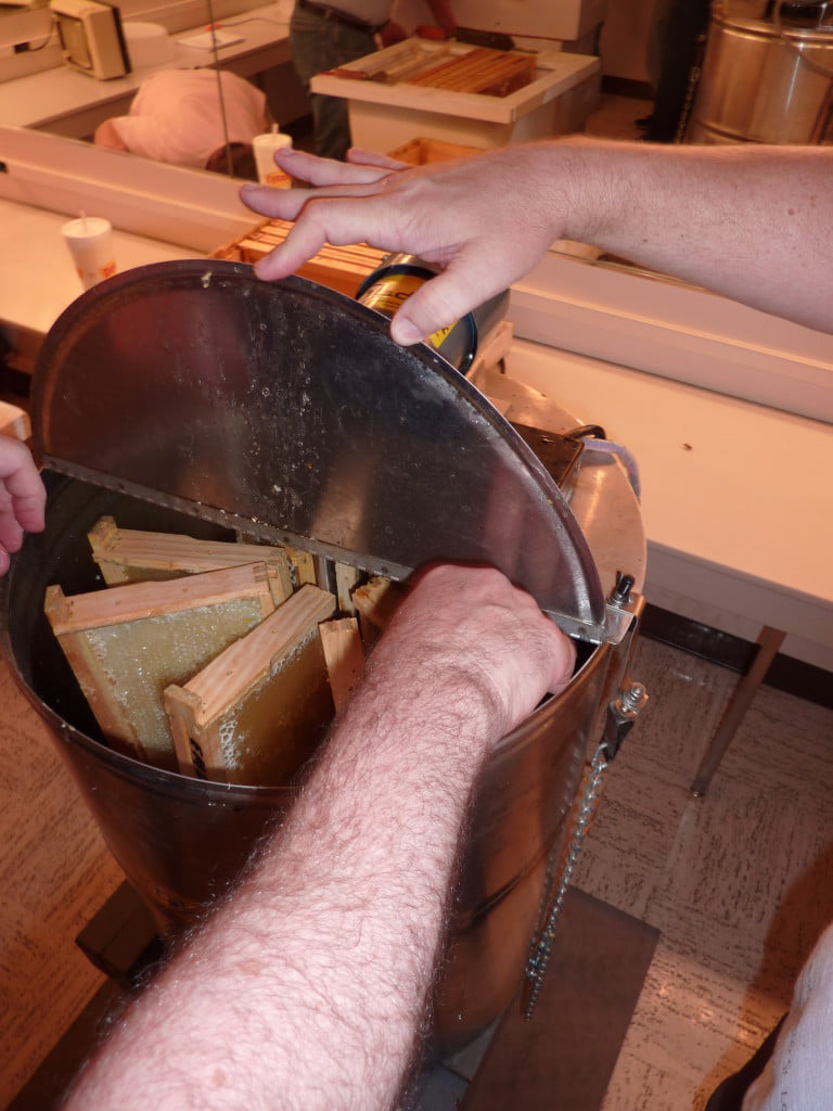 Loading medium honey frames in a 6 frame stainless steel centrifical force extractor